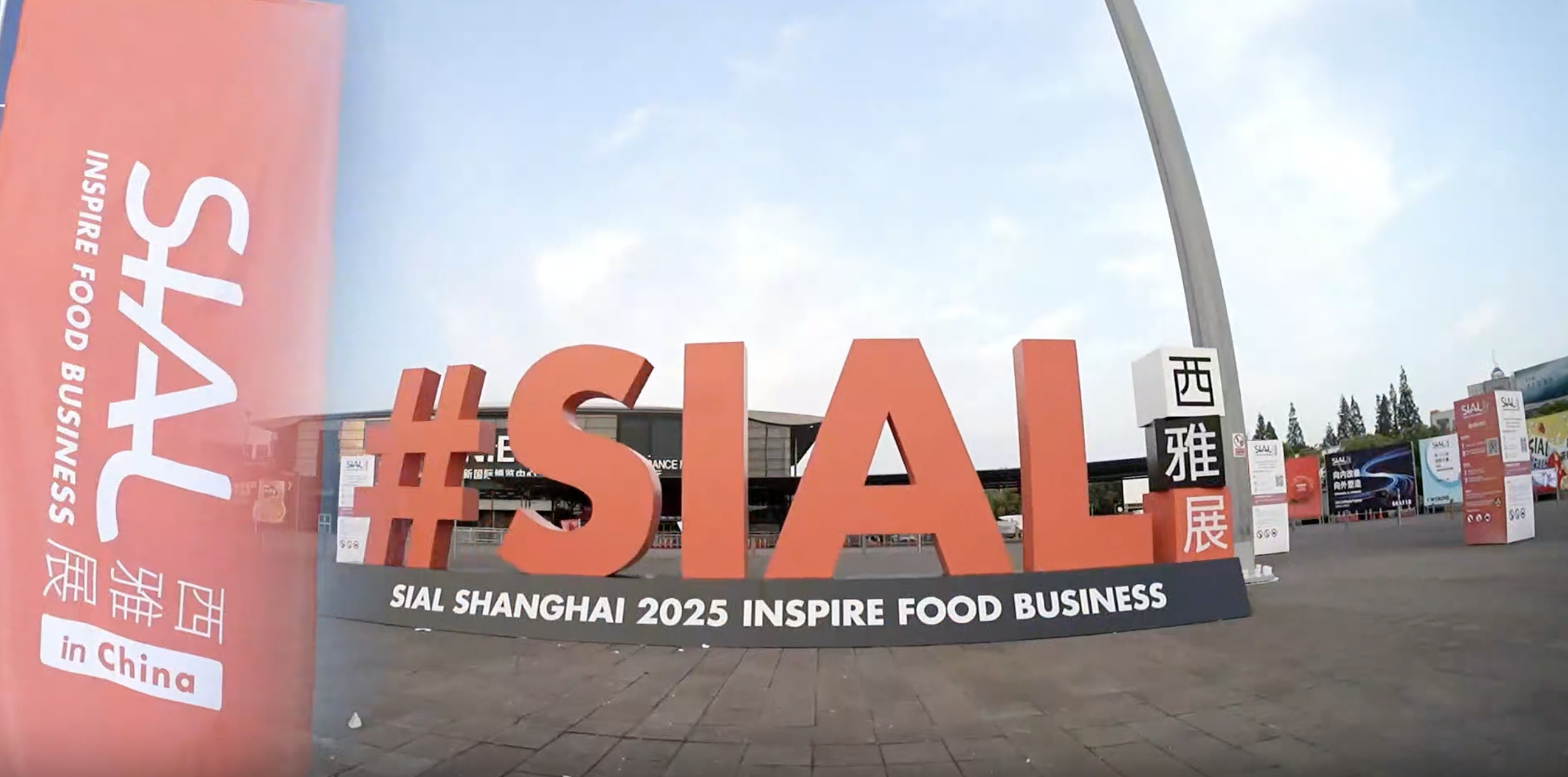 <img src="sial-shanghai-2025-outdoor-landmark.jpg" alt="SIAL Shanghai 2025 outdoor landmark sign featuring the hashtag SIAL in front of the exhibition center">