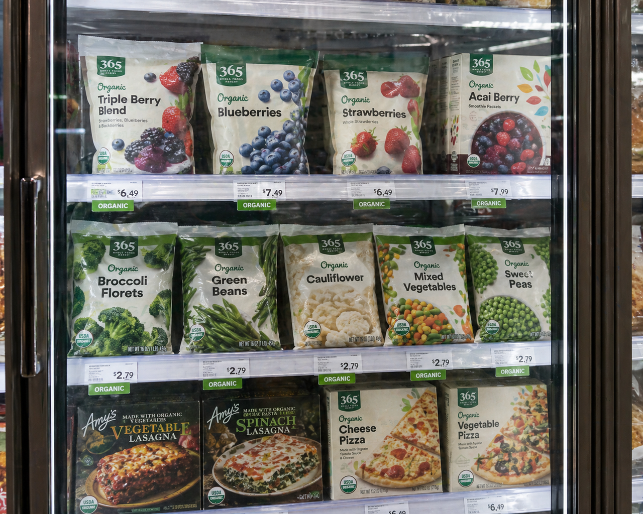organic frozen food in supermarket freezer including berries, vegetables, and meals