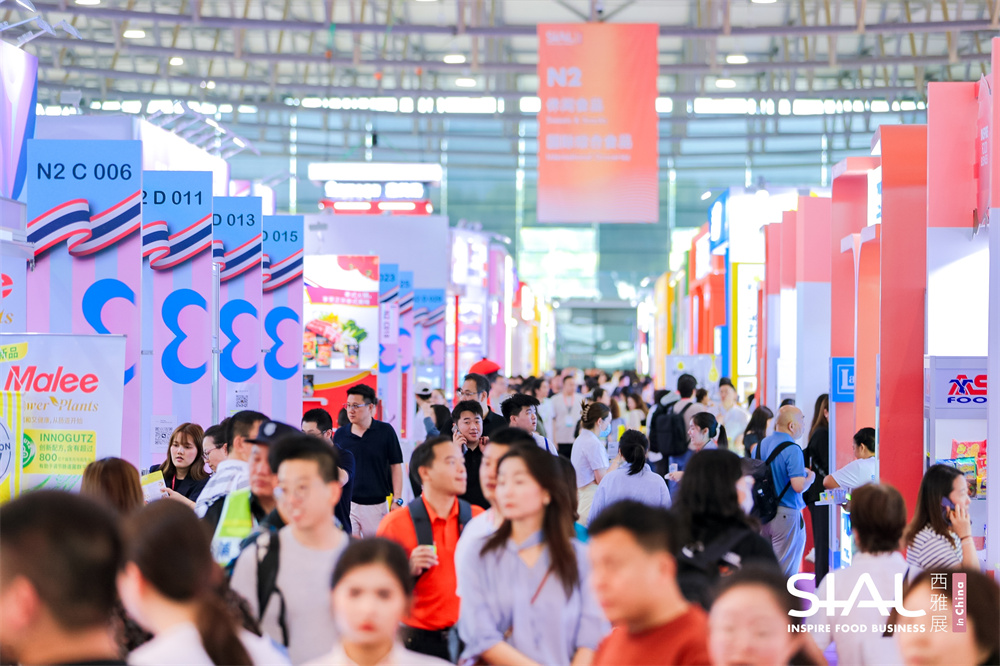 Crowded exhibition aisles and international food booths in Hall N2 at SIAL Shanghai 2026