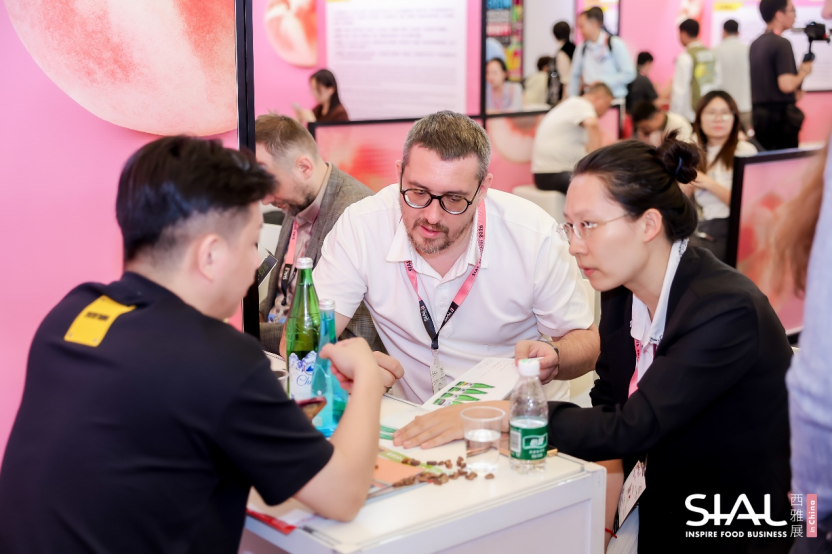 B2B match-making meeting with buyers reviewing product catalog at SIAL China