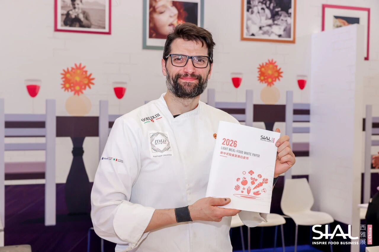 Chef showing the 2026 SIAL Light Meal and Food White Paper booklet