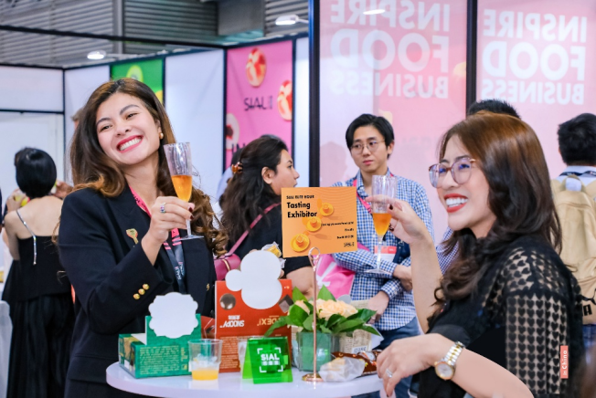 Guests networking and toasting with champagne inside the SIAL VIP Lounge
