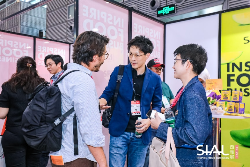 Networking scene at a SIAL in China exhibition booth