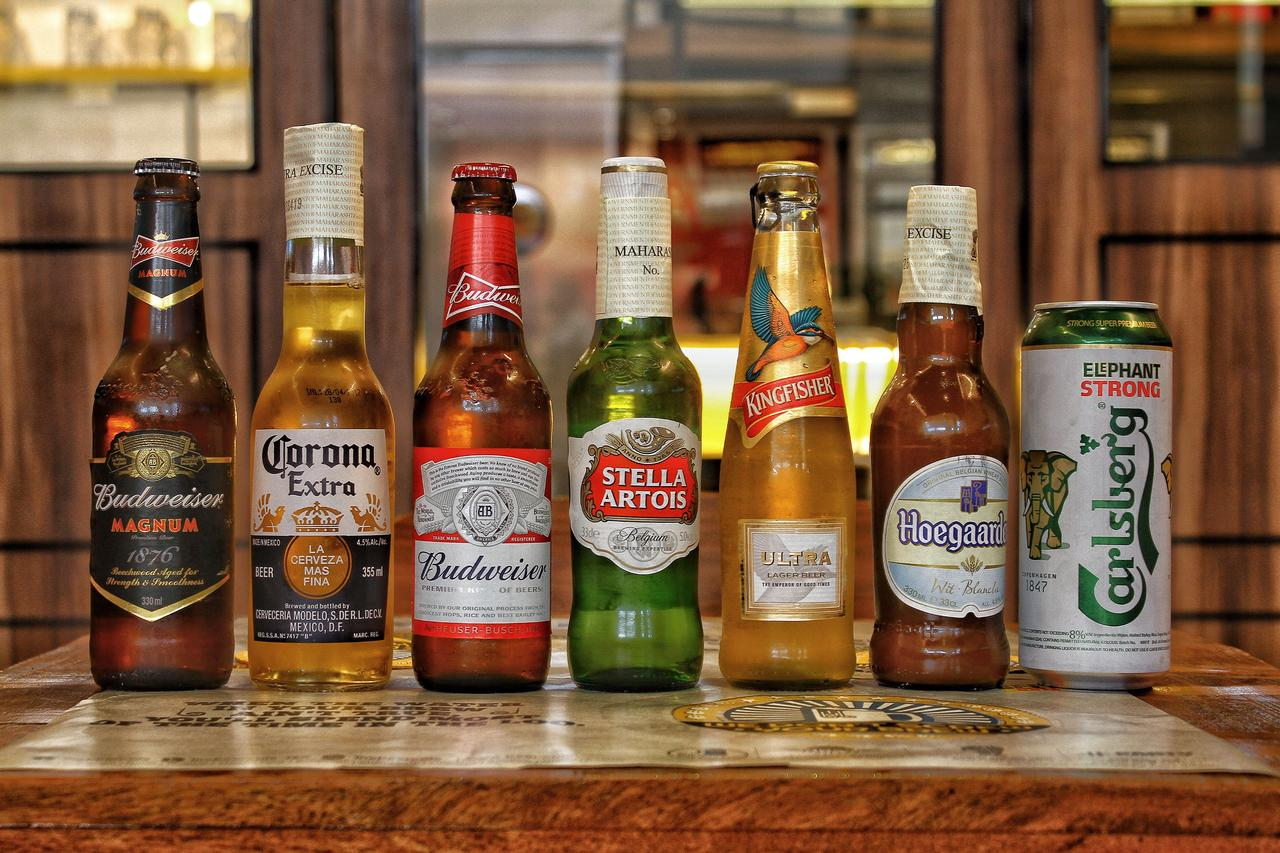 Collection of international beer bottles displayed on a bar counter
