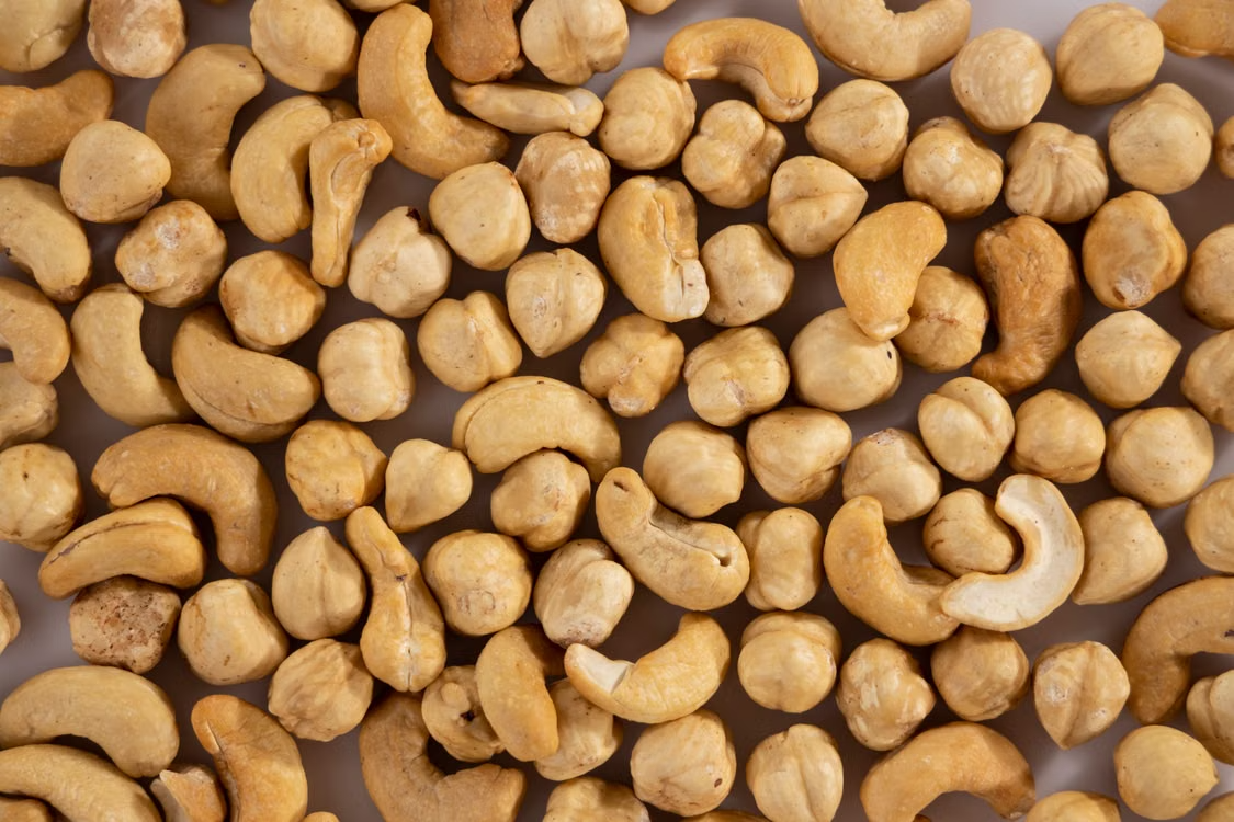 Close-up of assorted cashew and macadamia nuts, showcasing texture and variety