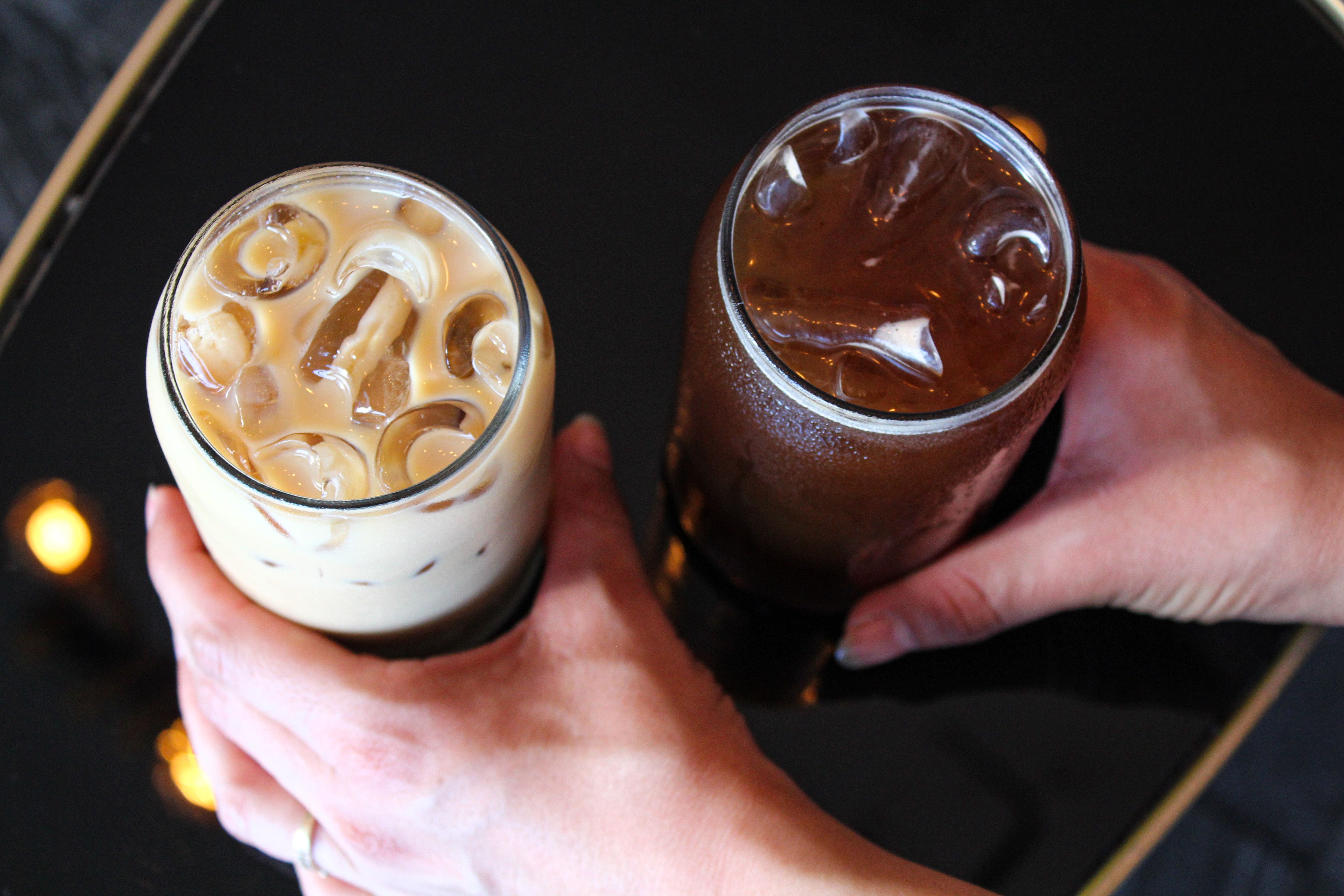 Top view of iced latte and iced black coffee served in glasses